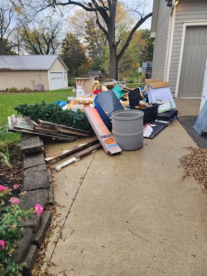Dumpster being loaded with debris for 10 Yard Dumpster Rental in Wingate
